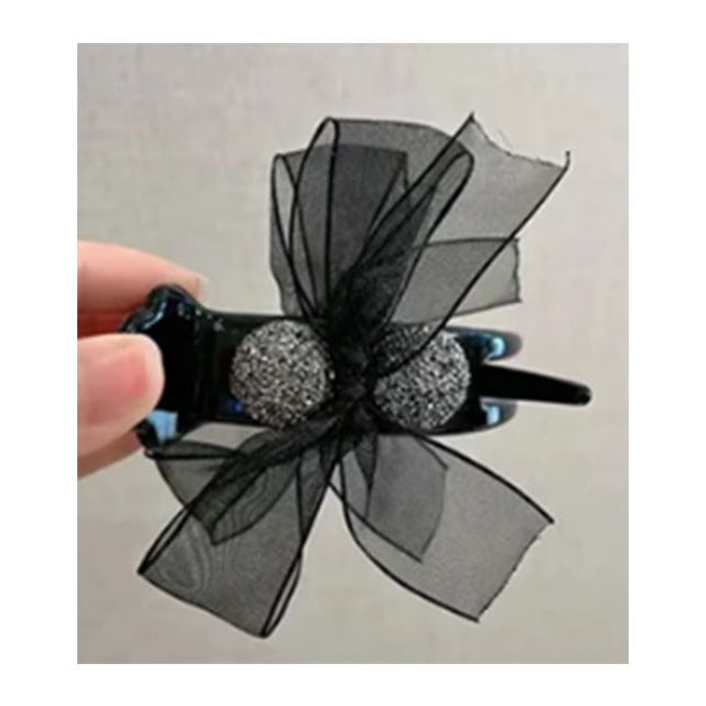 Haarklem met zwarte strik en glinsteringen